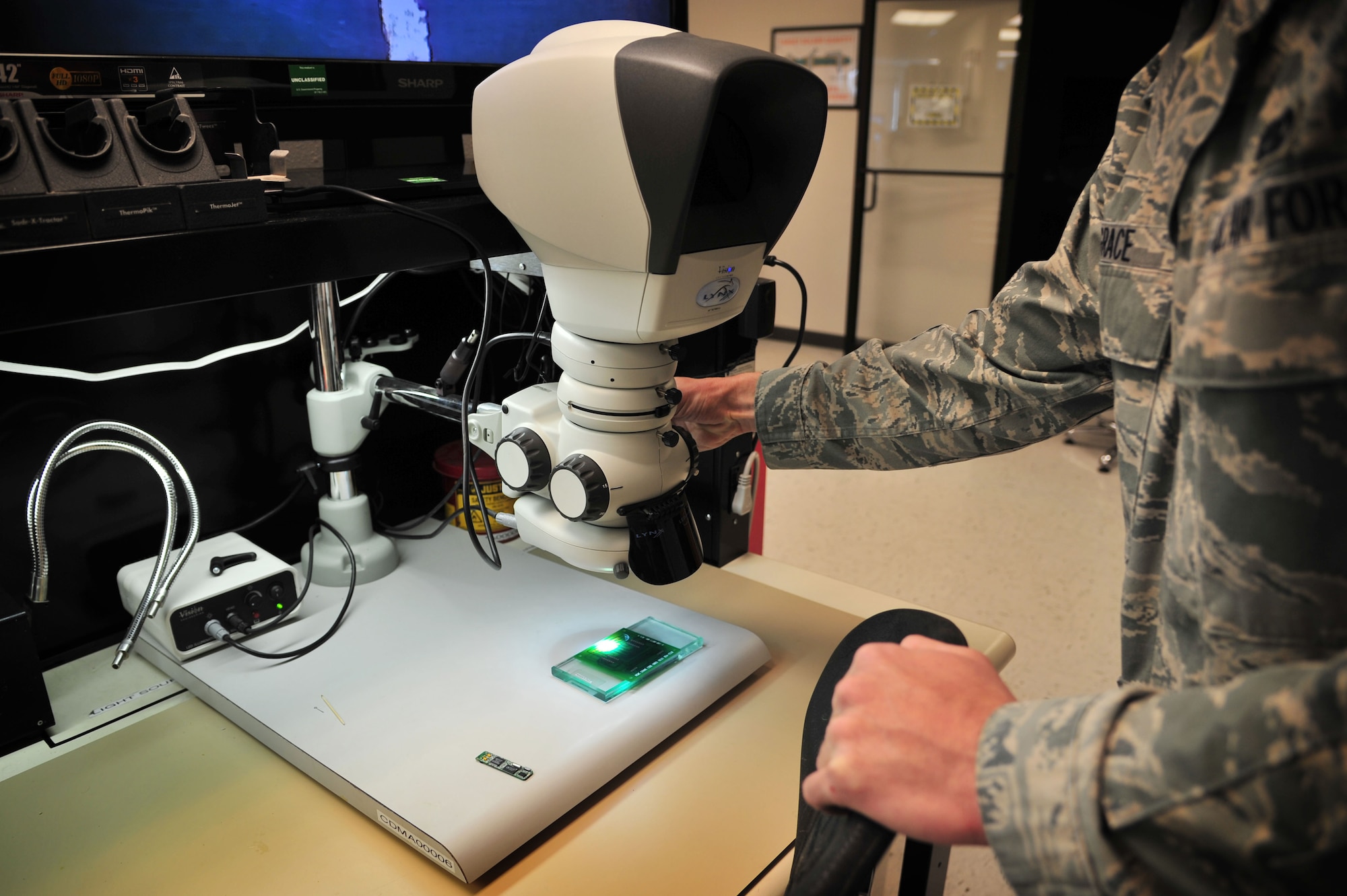A high-powered microscope is used to solder and repair electrical components in the Air Force Repair Enhancement Program shop at Cannon Air Force Base, N.M., Feb. 28, 2013. These Airmen attend a six-week Micro-Miniature Circuit Card Repair course at Davis-Monthan Air Force Base, Ariz., where they learn wire repair, advanced soldering techniques, circuit card repair and electronic re-work. (U.S. Air Force photo/Senior Airman Alexxis Pons Abascal) 