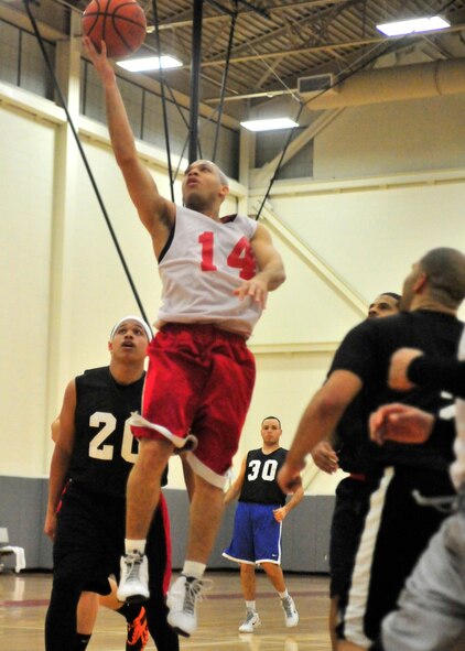 Antwan Piper, 436th Force Support Squadron player-coach, goes up for a layup against the 436th Maintenance Squadron during the intramural basketball championship Feb. 27, 2013, at the base fitness center on Dover Air Force Base, Del. The 436th FSS won the base championship defeating the 436th MXS 49-48. (U.S. Air Force photo/Tech. Sgt. Chuck Walker)