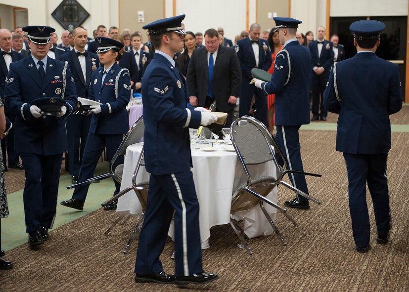 Malmstrom Honor Guard members place hats representing prisoners of war and persons missing in action within each branch of military service as part of the opening ceremonies for the Annual Awards Banquet. (U.S. Air Force photo/Beau Wade)
