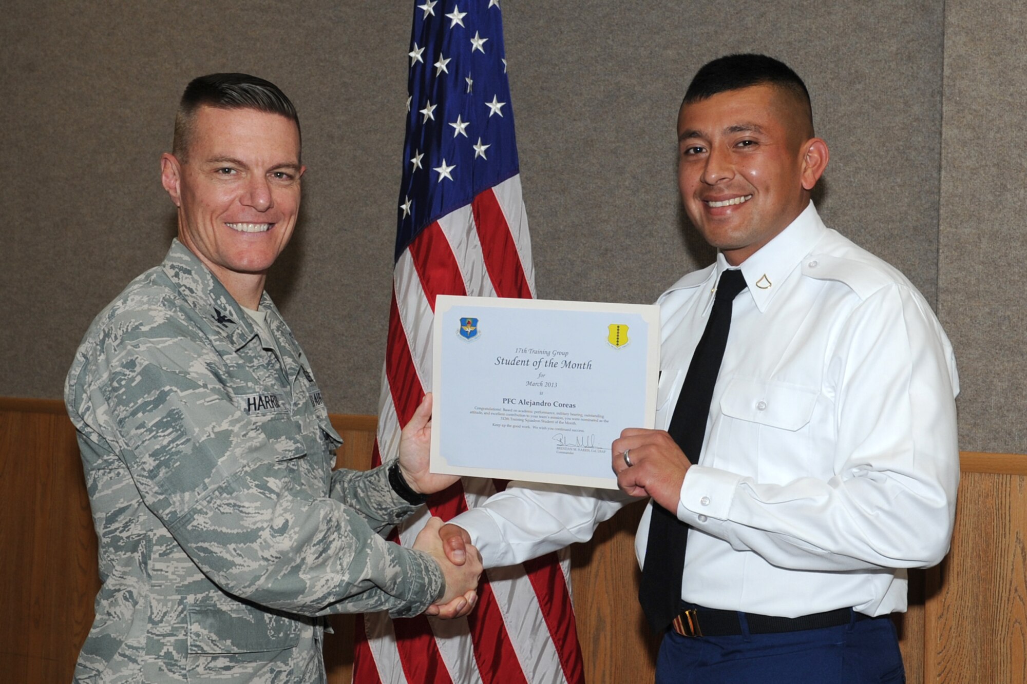 GOODFELLOW AIR FORCE BASE, Texas-- Col. Brendan Harris, 17th Training Group Commander, presents Army Pfc. Alejandro Coreas with the 312th Training Squadron Student of the Month award for February, March 1. (U.S. Air Force photo/Staff Sgt. Laura R. McFarlane)