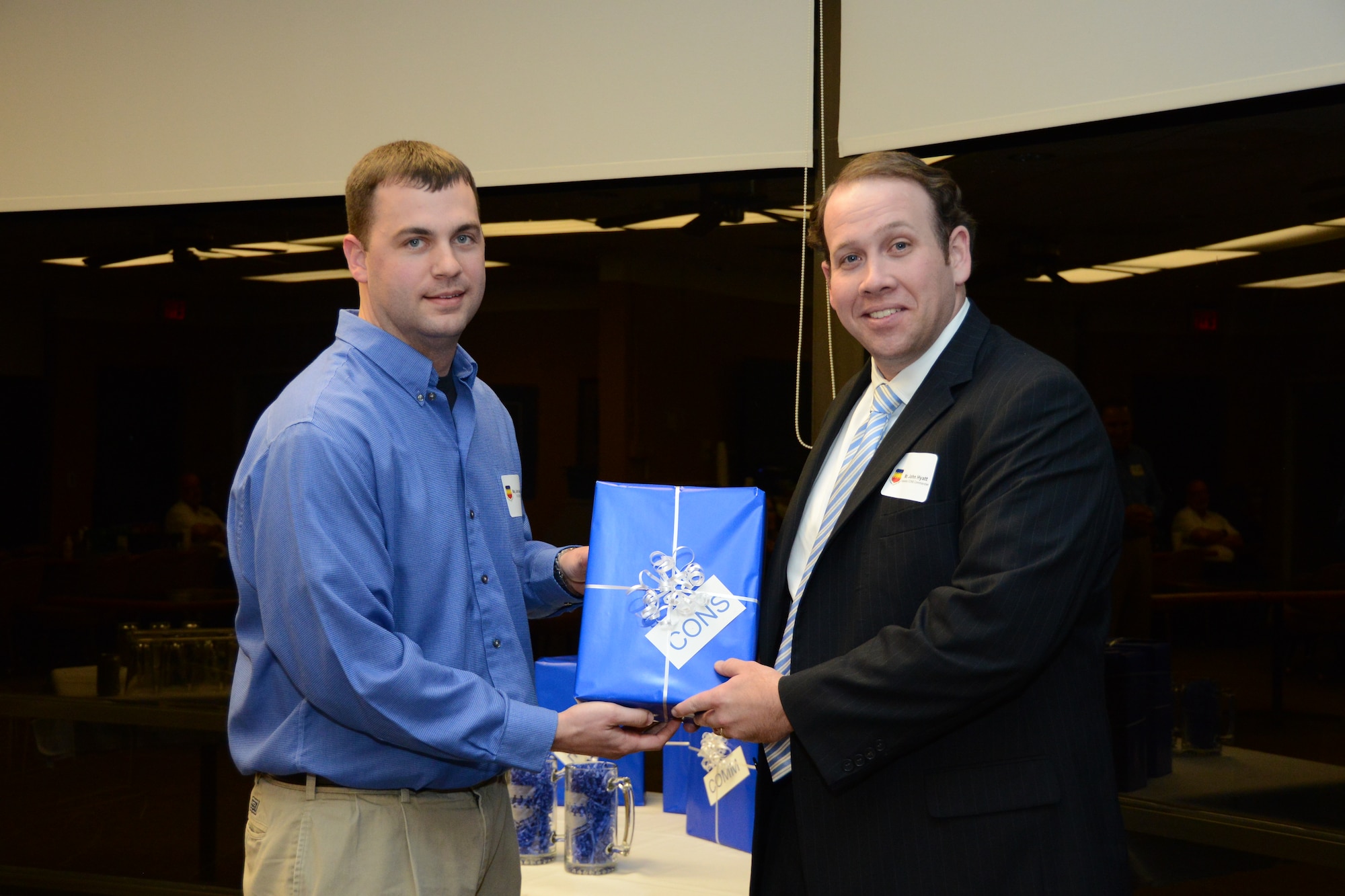 U.S. Air Force Maj. John Kendall, 20th Contracting Squadron commander, presents John Hyatt, Merrill Lynch advisor  with a small gift at the 20th Mission Support Group honorary commander dinner  at the Carolina Skies Golf Course here Feb. 28, 2013.  The purpose of the Air Force honorary commander program is to build relationships with members of the local community and encourage them to share the AF story.  (U.S. Air Force photo by Capt. Ann Blodzinski/Released)