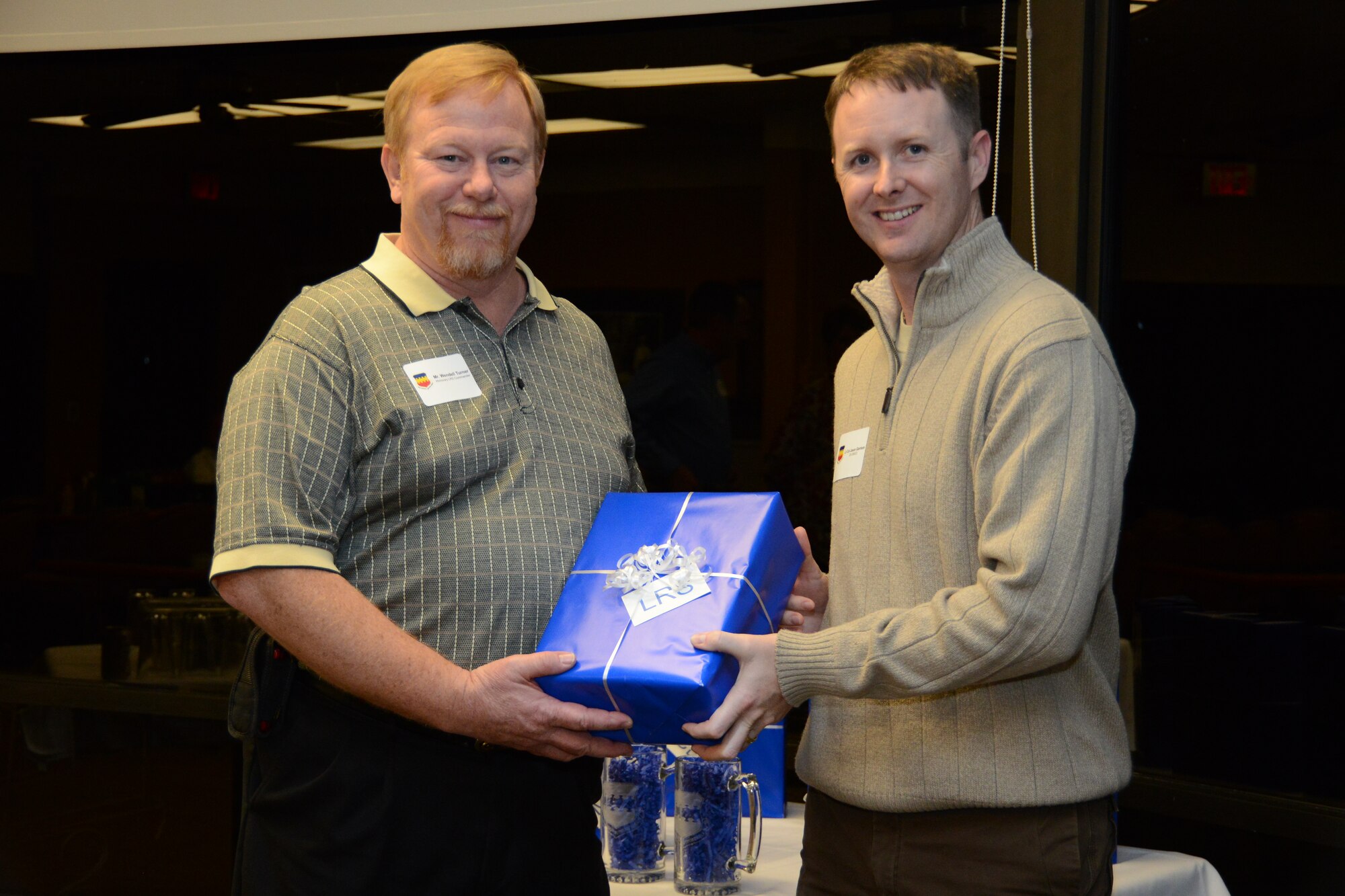 U.S. Air Force Maj. Jason Garrison, 20th Logistics Squadron commander, presents Wendall Turner, Turner's Garage and Transmission owner with a small gift at the 20th Mission Support Group honorary commander dinner  at the Carolina Skies Golf Course here Feb. 28, 2013.  The purpose of the Air Force honorary commander program is to build relationships with members of the local community and encourage them to share the AF story.  (U.S. Air Force photo by Capt. Ann Blodzinski/Released)