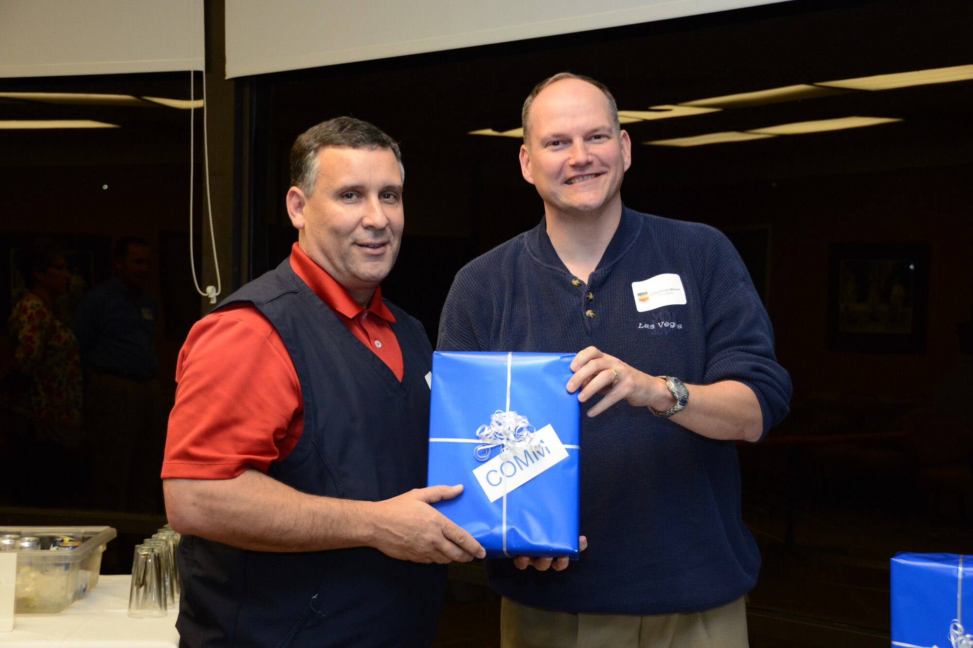 U.S. Air Force Lt. Col Kevin Wilson, 20th Communication's Squadron commander, presents William "Chip" Chase, Farmer's Telephone Cooperative public relations director with a small gift at the 20th Mission Support Group honorary commander dinner  at the Carolina Skies Golf Course here Feb. 28, 2013.  The purpose of the Air Force honorary commander program is to build relationships with members of the local community and encourage them to share the AF story.  (U.S. Air Force photo by Capt. Ann Blodzinski/Released)