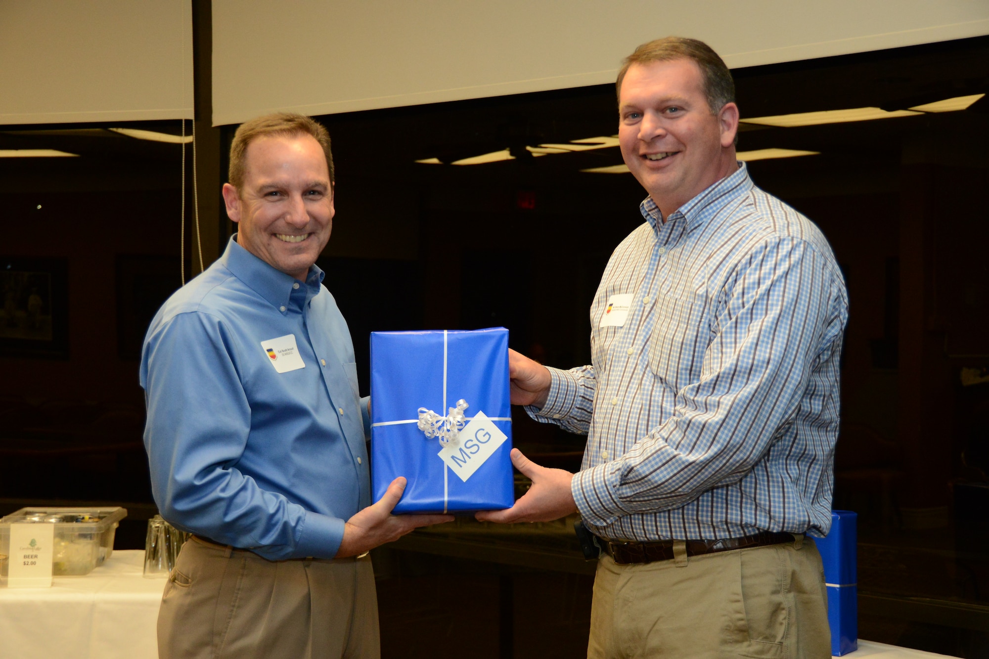U.S. Air Force Col. Scott Arcuri, 20th Mission Support Group commander, presents Deron McCormick, City of Sumter city manager with a small gift at the 20th MSG honorary commander dinner at the Carolina Skies Golf Course here Feb. 28, 2013.  The purpose of the Air Force honorary commander program is to build relationships with members of the local community and encourage them to share the AF story.  (U.S. Air Force photo by Capt. Ann Blodzinski/Released)