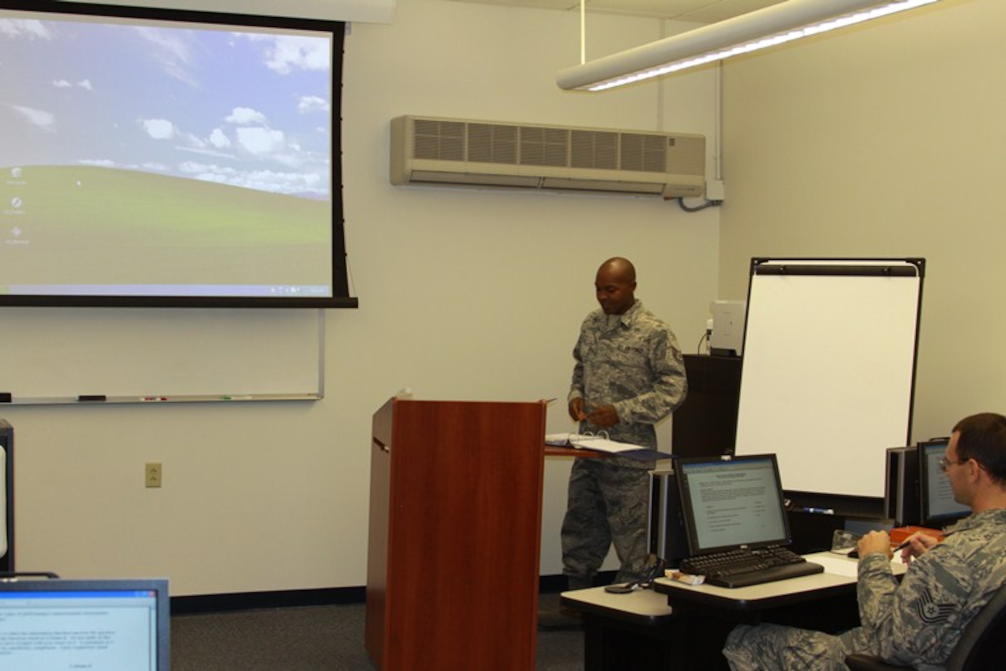 Tech. Sgt. Corey Fosque (then Staff Sgt.) (front left), F-22 avionics instructor for the 372nd Training Squadron's Field Training Detachment 18 at Joint Base Langley-Eustis, Va., teaches the Principles of Instruction course to security forces personnel in October, 2012. Making the POI course available at 982nd Training Group detachments has saved the Air Force over $1.1 million in approximately five months. (U.S. Air Force courtesy photo)