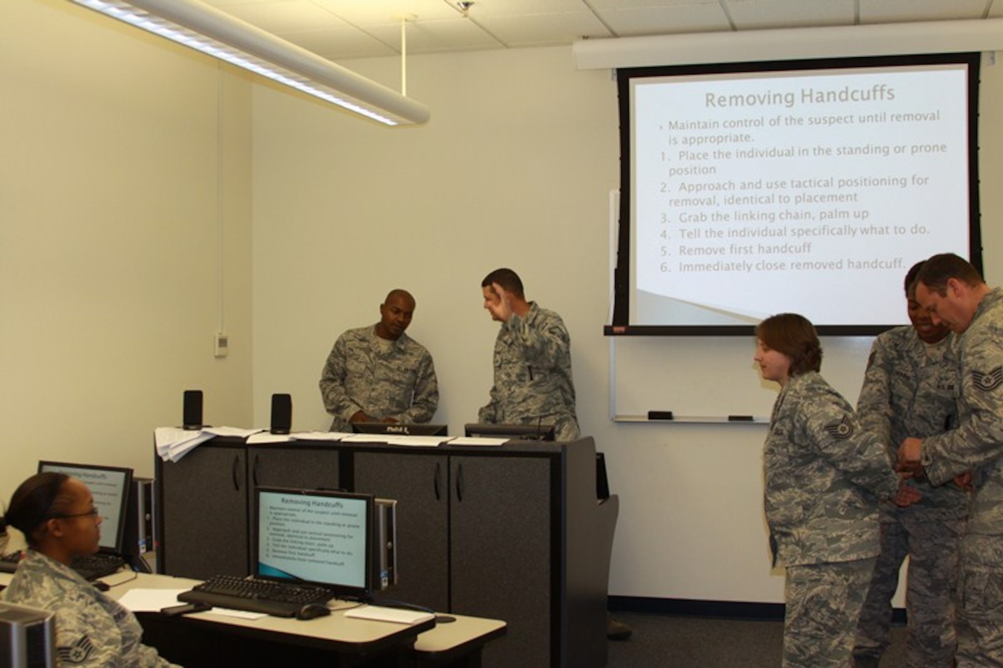 Tech. Sgt. Corey Fosque (then Staff Sgt.) (front left), F-22 avionics instructor for the 372nd Training Squadron's Field Training Detachment 18 at Joint Base Langley-Eustis, Va., teaches the Principles of Instruction course to security forces personnel in October, 2012. Making the POI course available at 982nd Training Group detachments has resulted in 396 students being trained and a cost avoidance of approximately $1.1 million for the Air Force over five months. (U.S. Air Force courtesy photo). 