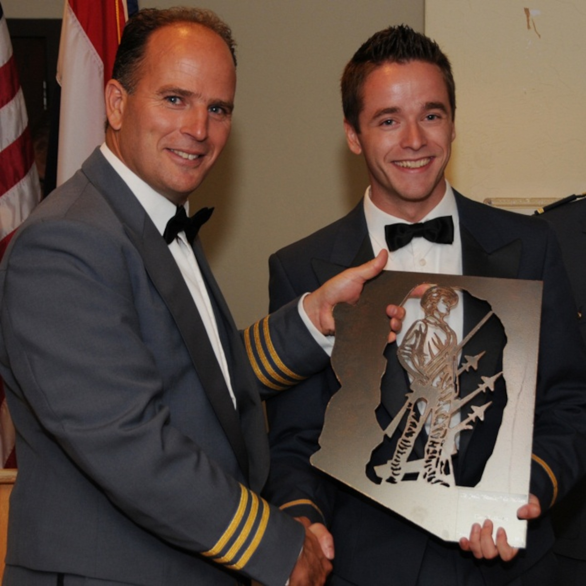 Royal Netherlands Air Force Lt. Col Maurits Schonk, Commander of the Netherlands Detachment at the 148th Fighter Squadron, presents an award to 1st Lt. Jorik DeBakker at an August 2012 Dutch graduation ceremony. (U.S. Air Force photo by Master Sgt. David Neve/Released)