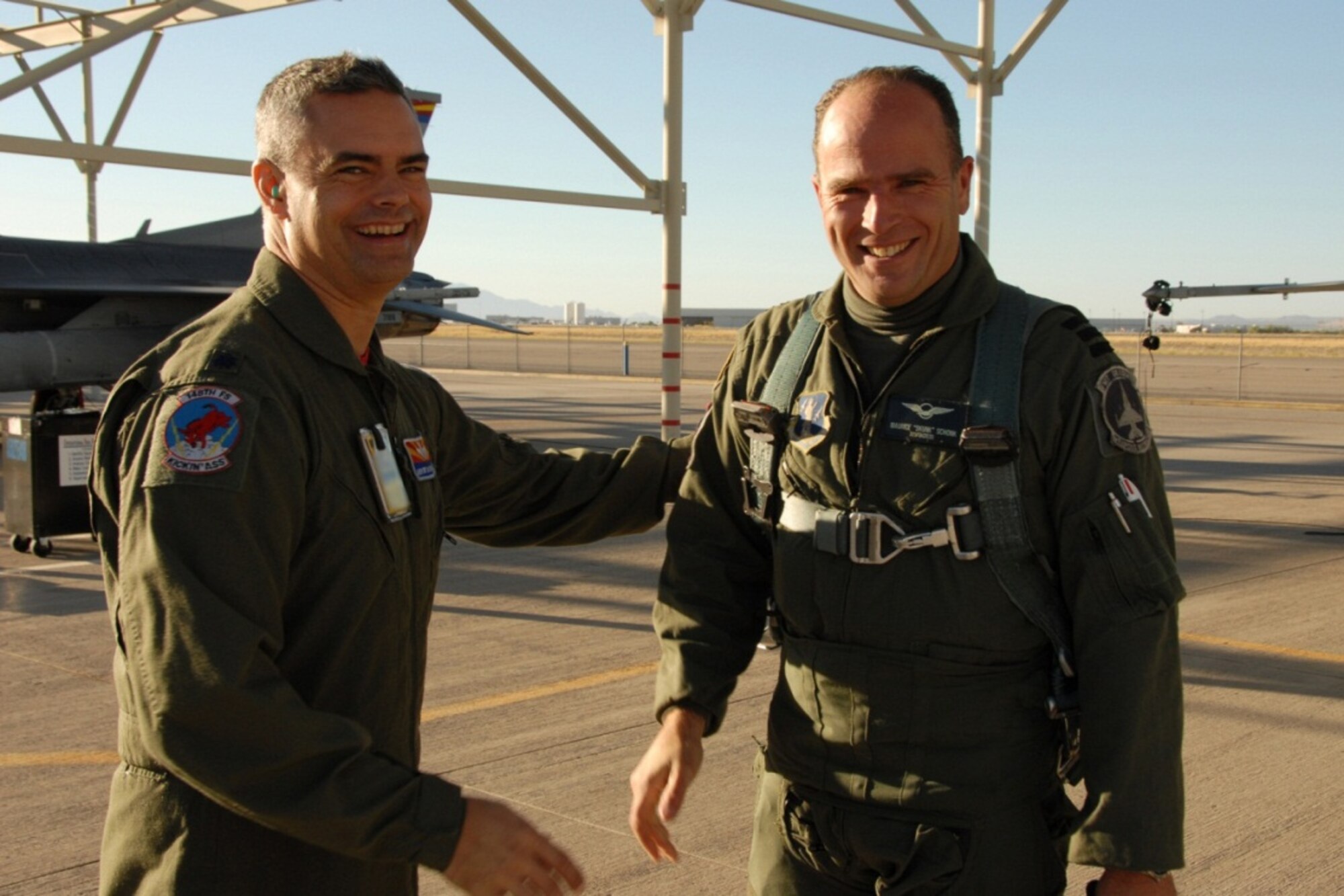 Royal Netherlands Air Force Lt. Col. Maurits Schonk, Commander of the Netherlands Detachment at the 148th Fighter Squadron, is greeted by Maintenance Group Commander Col. Andrew MacDonald at the 162nd Fighter Wing in Tucson, Ariz., October 29, 2010. Lt. Col. Schonk had just delivered the first of ten Dutch F-16 Fighting Falcons to the Wing to be used for pilot training. (U.S. Air Force photo by Master Sgt. David Neve/Released) 