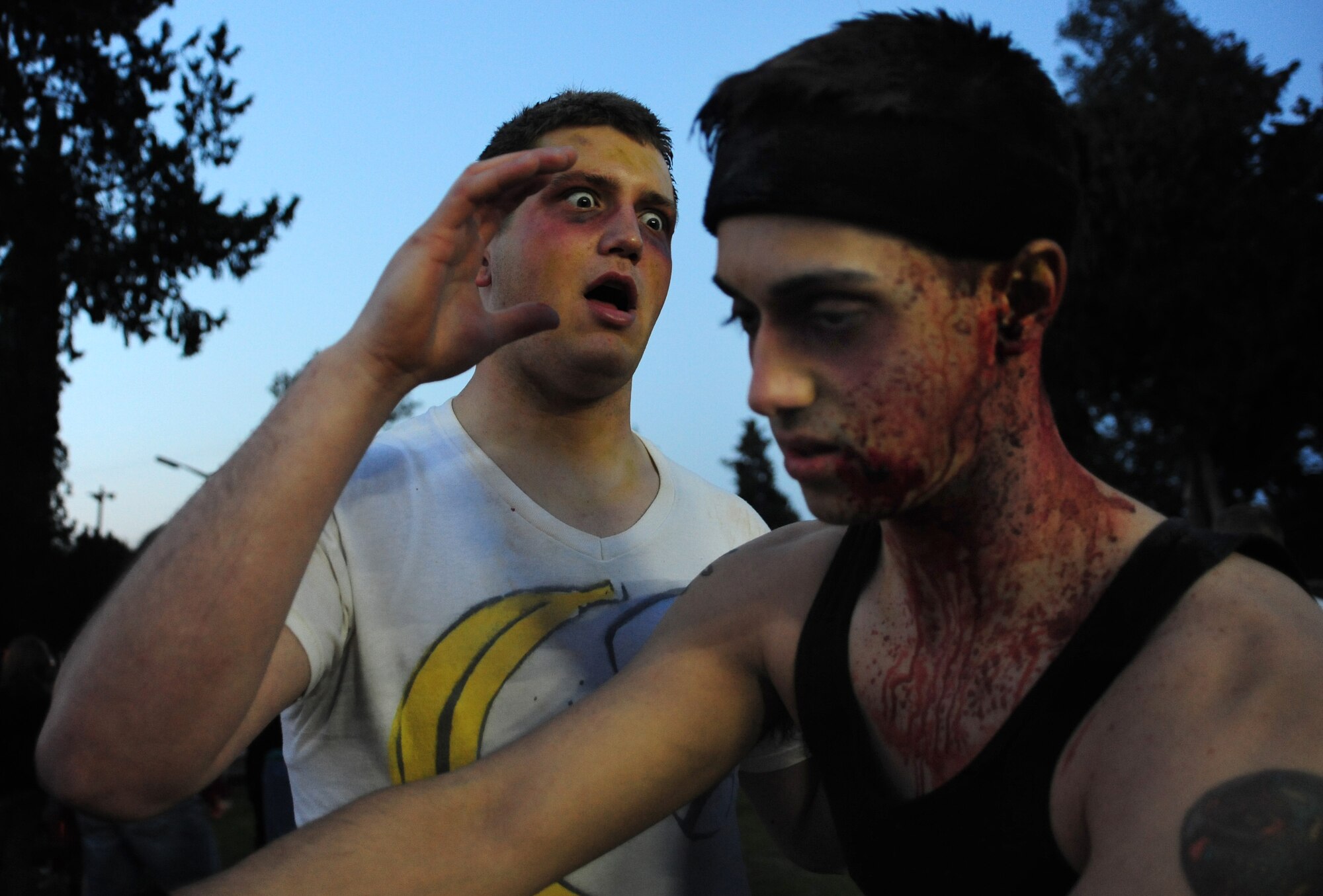 Senior Airman Nathan Tingley and Airman 1st Class William Allison, 39th Communications Squadron cyber transport systems technicians, show off their zombie moves during the 39th Force Support Squadron zombie run March 2, 2013, at Incirlik Air Base, Turkey. Tingley finished in fourth place with a total of 16 survivor flags taken. (U.S. Air Force photo by Senior Airman Anthony Sanchelli/Released)