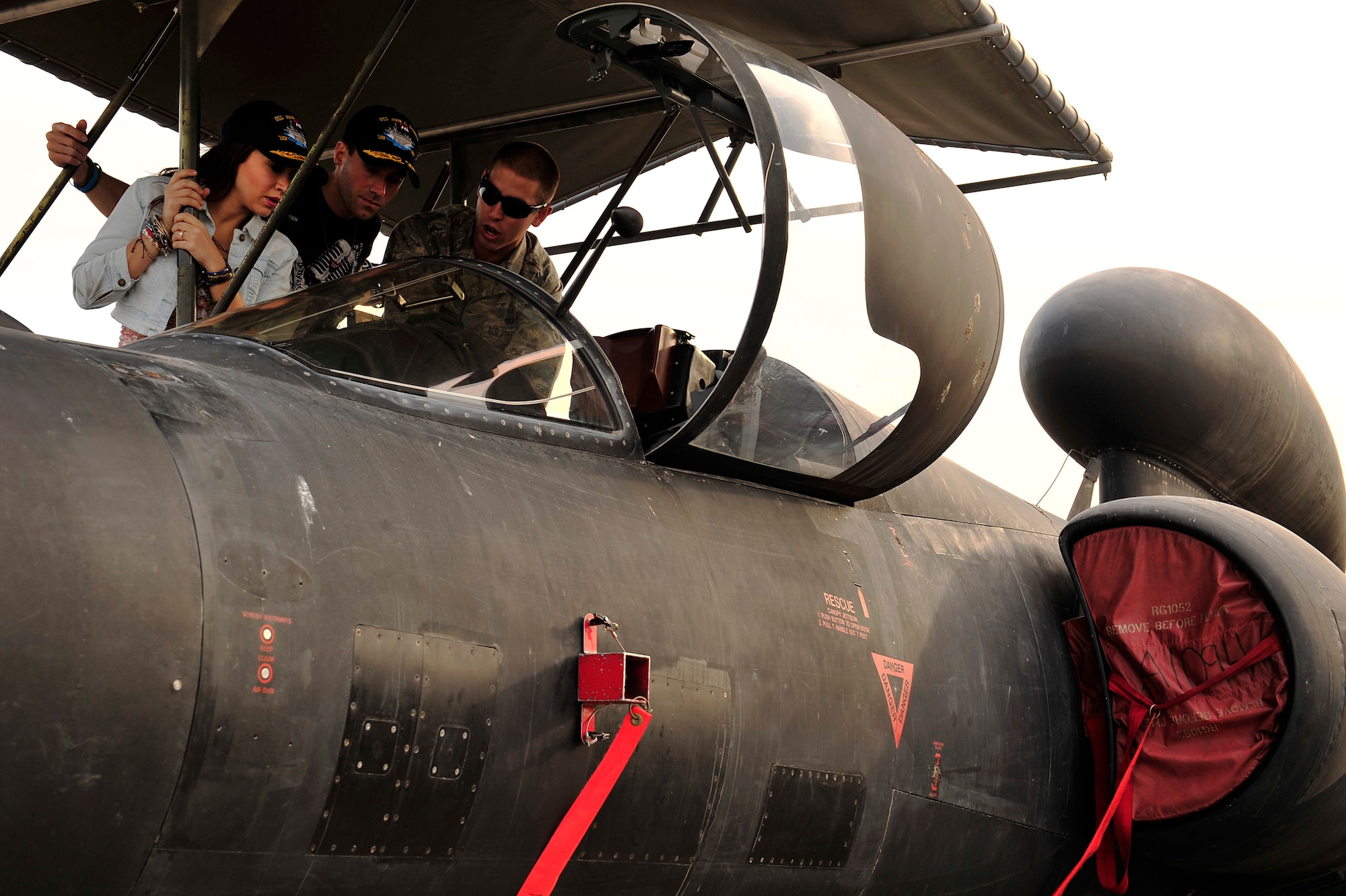 U.S. Air Force Airman 1st Class Charles Hayes, 380th Expeditionary Aircraft Maintenance Squadron U-2 assistant dedicated crew chief, gives a U-2 cockpit tour to American Idol stars Diana Degarmo and Ace Young at an undisclosed location in Southwest Asia Feb. 28, 2013. Degarmo and Young visited the men and women of the 380th Air Expeditionary Wing to express the country’s gratitude for their service and sacrifice during the Vice Chairman of the Joint Chiefs of Staff Adm. James A. Winnefeld USO tour. (U.S. Air Force photo by Tech. Sgt. Christina M. Styer/Released)