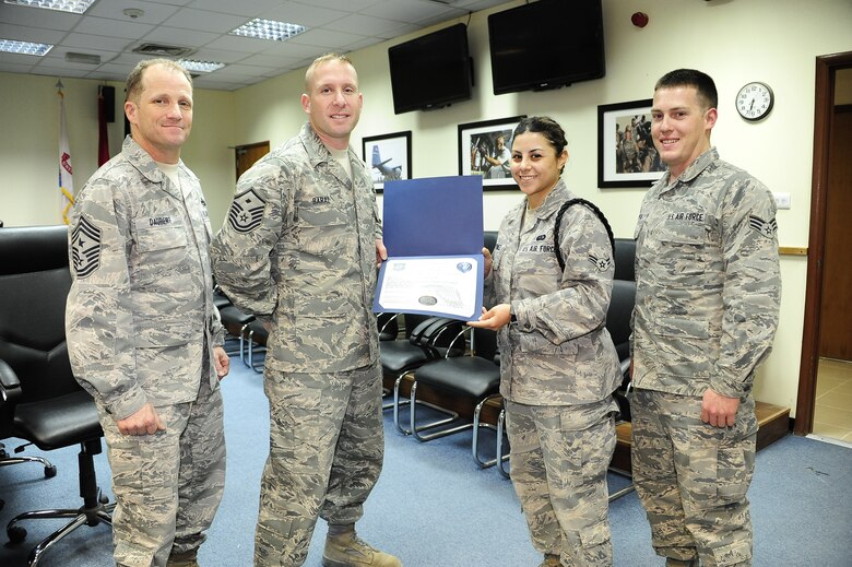 Airmen 1st Class Christina Jimenez presents Master Sgt. Daniel Baraz with a certificate of appreciation for his support with the Rising Four Council.