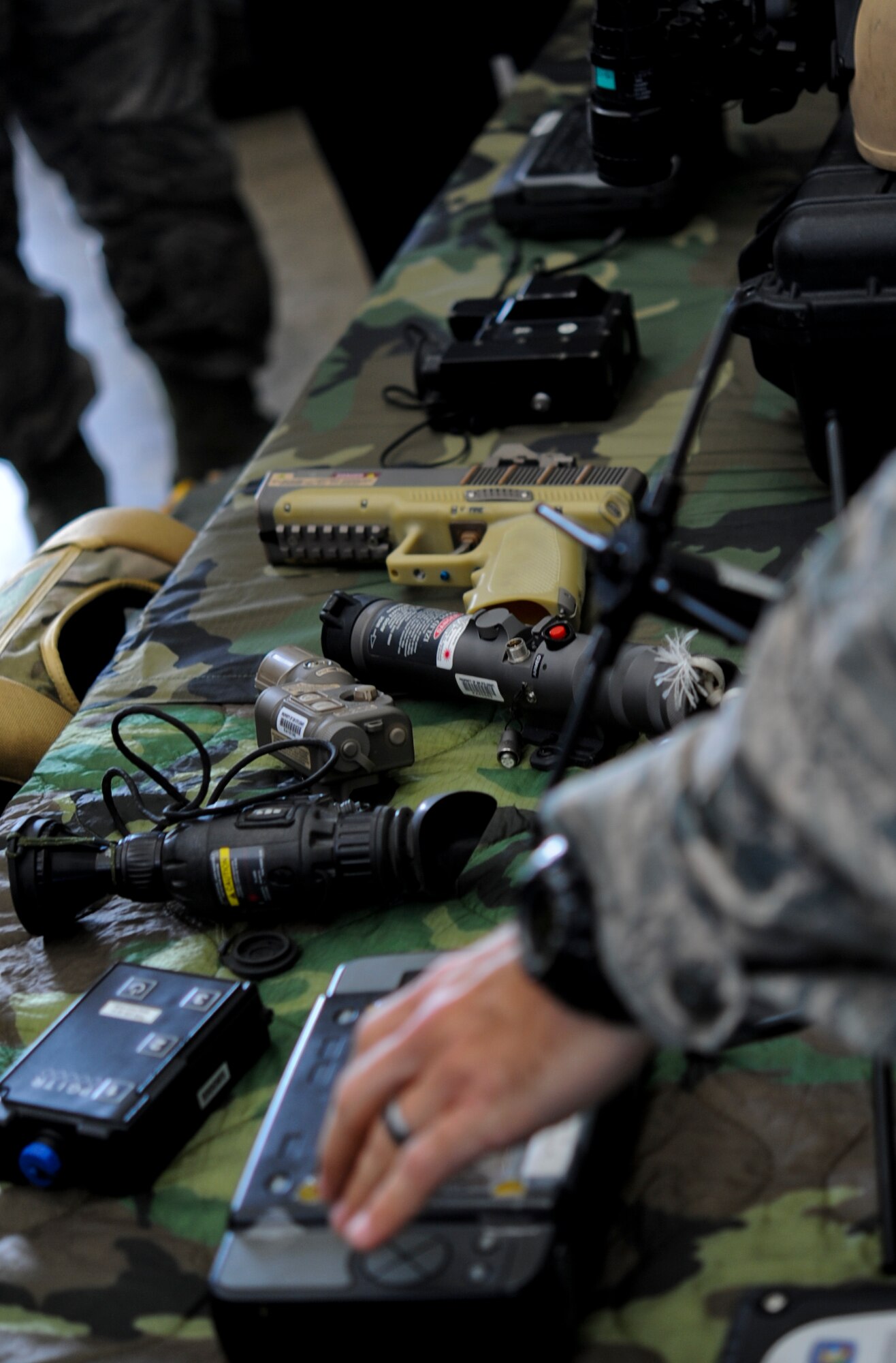 U.S. Air Force Master Sgt. Scott Seamone, 320th Special Tactics Squadron current operations manager NCO in charge, shows members of the Japan Air Self Defense Force some of their equipment during a JASDF visit to the 353rd Special Operations Group on Kadena Air Base, Japan, Feb. 26, 2013. The 353rd SOG is the focal point for all U.S. Air Force special operations activities throughout the U.S. Pacific Command theater, which is comprised of more than 750 Airmen and five squadrons. (U.S. Air Force photo/Airman 1st Class Justin Veazie)