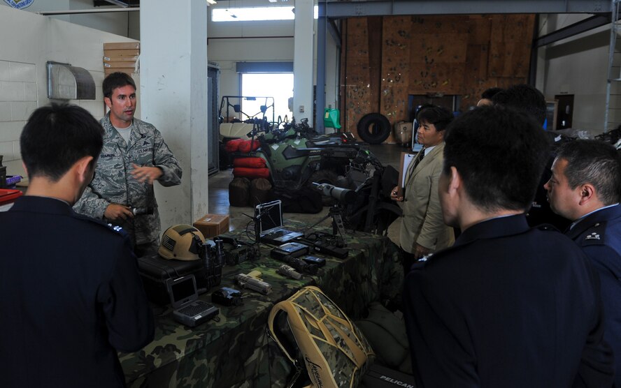 U.S. Air Force Master Sgt. Scott Seamone, 320th Special Tactics Squadron current operations manager NCO in charge, talks to members of the Japan Air Self Defense Force about some of their equipment during a JASDF visit to the 353rd Special Operations Group on Kadena Air Base, Japan, Feb. 26, 2013. The 320th STS pararescuemen and combat controllers provide for the establishment of drop and landing zones, air traffic control to the landing zone, combat medical care and evacuation, and combat search and rescue for both fixed and rotary wing assets. (U.S. Air Force photo/Airman 1st Class Justin Veazie)