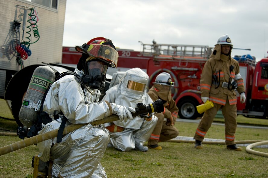 American firefighters from Kadena Air Base’s 18th Civil Engineer Squadron and Okinawan firefighters from Okinawa City maintain a safe perimeter around a simulated aircraft incident as part of a bilateral field training exercise on Torii Station, Japan, Feb. 26, 2013. The FTX gave U.S. military and Okinawa City first responders the opportunity to train together in the event a U.S. military aircraft goes down in the local community. (U.S. Air Force photo/Senior Airman Maeson L. Elleman) 

