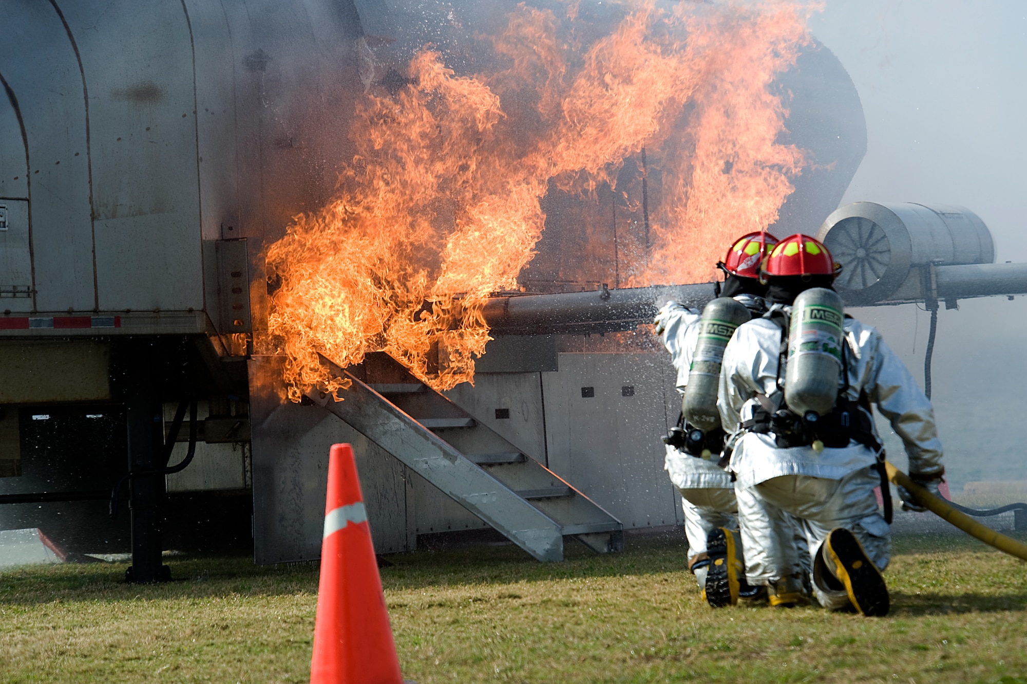 U.S. Air Force firefighters from Kadena’s 18th Civil Engineer Squadron work to extinguish a simulated aircraft fire during a bilateral field training exercise on Torii Station, Japan, Feb. 26, 2013. The FTX gave U.S. military and Okinawa City first responders the opportunity to train together in the event a U.S. military aircraft goes down in the local community. By working together, the two nations can ensure any future situation is handled well while minimizing damage and casualties. (U.S. Air Force photo/Senior Airman Maeson L. Elleman)