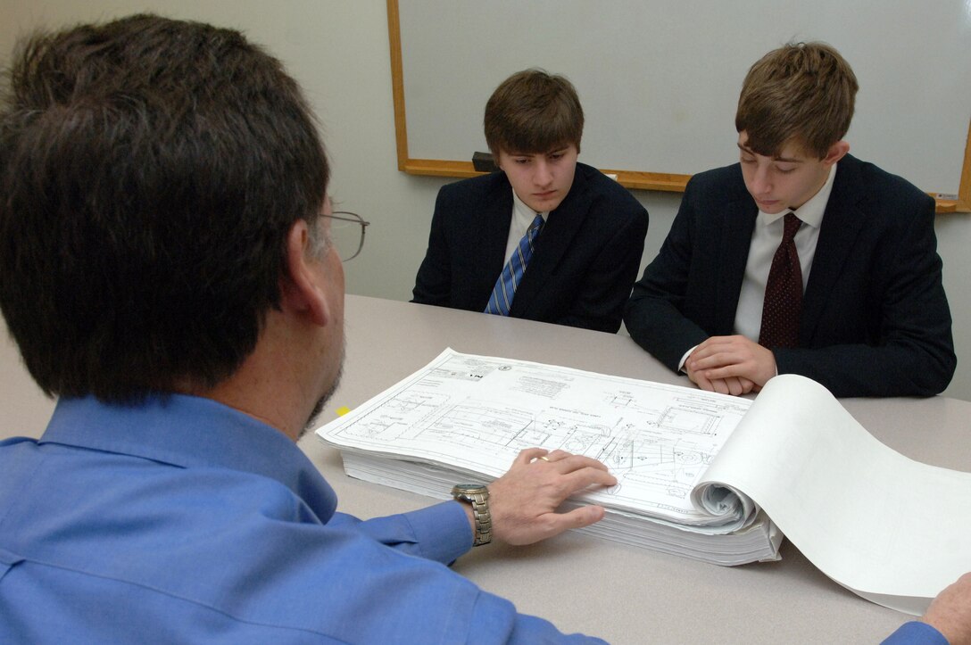 Ron Carter (Left), chief of the Civil and Structural Section at the U.S. Army Corps of Engineers Nashville District, shows engineering diagrams to Montgomery Bell Academy Sophomores Jack Sonday (Middle) and Greg Quesinberry at the district headquarters in Nashville, Tenn., March 1, 2013. (USACE photo by Lee Roberts)