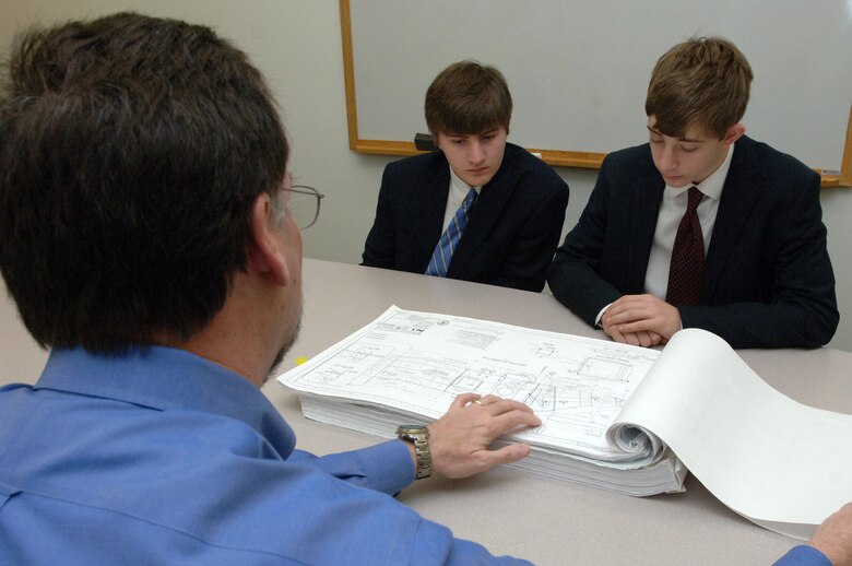 Ron Carter (Left), chief of the Civil and Structural Section at the U.S. Army Corps of Engineers Nashville District, shows engineering diagrams to Montgomery Bell Academy Sophomores Jack Sonday (Middle) and Greg Quesinberry at the district headquarters in Nashville, Tenn., March 1, 2013. (USACE photo by Lee Roberts)