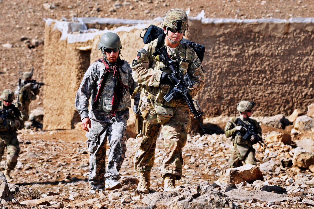 U.S. Army Spc. Leopoldo Valdez, center, patrols through the city of Chorah in the Tarin Kowt district of Afghanistan's Uruzgan province, Feb. 22, 2013. Valdez, a combat medic, is assigned to the 3rd Infantry Division’s Company C, 2nd Brigade Combat Team.