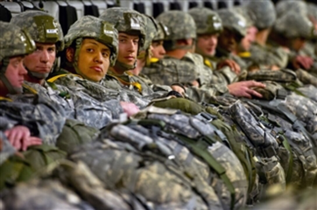 U.S. Army soldiers wait with their parachutes aboard an Air Force C-17 Globemaster III aircraft during a joint operational access exercise at Fort Bragg, N.C., on Feb. 25, 2013.  The exercise enhances cohesiveness between U.S. Army, Air Force and allied personnel, allowing the services an opportunity to properly execute large-scale heavy equipment and troop movement.  