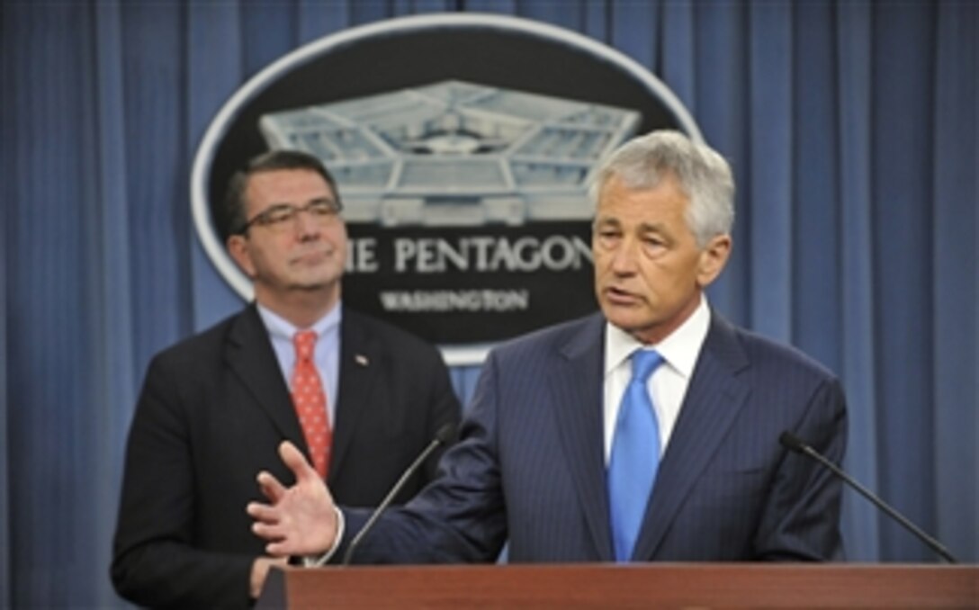 Secretary of Defense Chuck Hagel, right, talks about the onset of the sequester and the grave impact it will have on national security and the readiness of the military in his first press briefing at the Pentagon on March 1, 2013.   After taking initial questions from the press, Hagel introduced Deputy Secretary of Defense Ashton B. Carter, left, who provided reporters with more details about the impending steep cuts.  