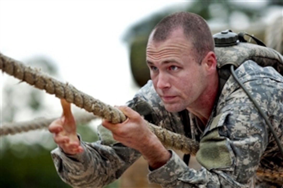 U.S. Army 2nd Lt. Marin Lohn pulls himself along a rope as he tackles the obstacle course of the Ranger Training Assessment Course at the Army National Guard Warrior Training Center on Fort Benning, Ga., on Feb.16, 2013.  Lohn is attached to the 2nd Battalion, 16th Cavalry Regiment, 316th Cavalry Brigade.  