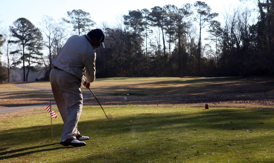 Bill Bartley, a representative of Defense Logistics Agency, tees off at one of the holes during the Big Game challenge at the Paradise Point Golf Course aboard Marine Corps Base Camp Lejeune Feb. 3. The Scarlett golf course consists of an 18-hole par 70 and was shortened to focus on player's short game for the Big Game challenge the morning of the super bowl.