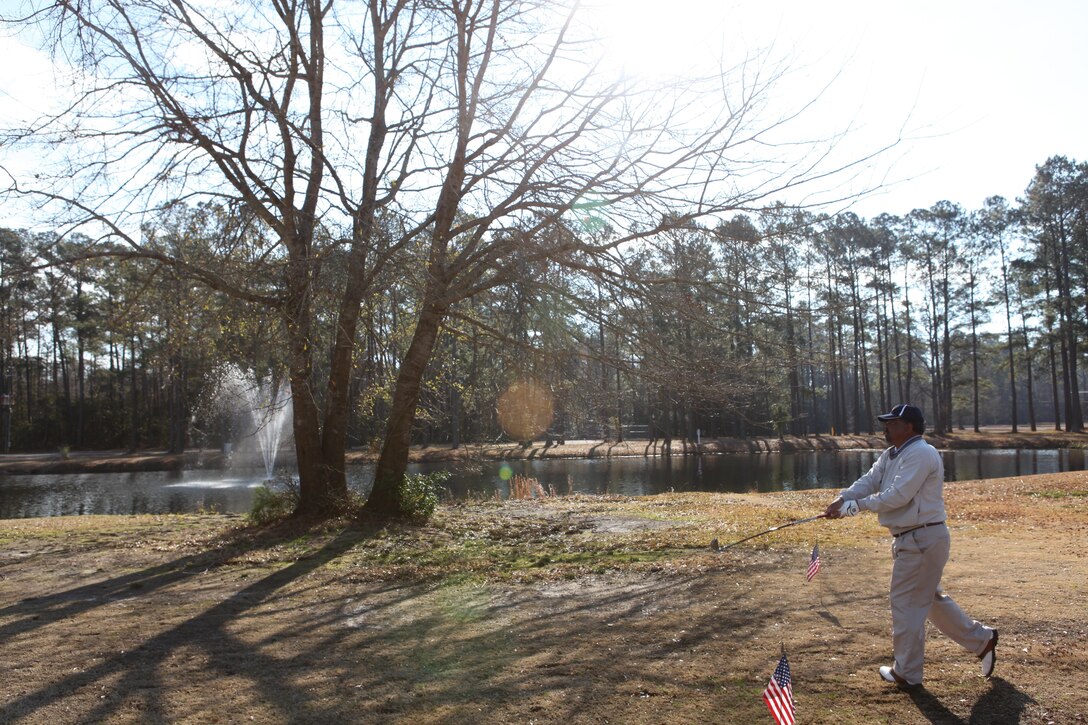 Bill Bartley, a representative of Defense Logistics Agency, tees off at one of the holes during the Big Game challenge at the Paradise Point Golf Course aboard Marine Corps Base Camp Lejeune Feb. 3. The Scarlett golf course consists of an 18-hole par 70 and was shortened to focus on player's short game for the Big Game challenge the morning of the super bowl.