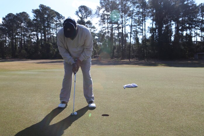 Bill Bartley, a representative of Defense Logistics Agency, putts the ball during the Big Game challenge at Paradise Point Golf Course aboard Marine Corps Base Camp Lejeune Feb. 3. The Big Game challenge was set up to allow golfers of all ages the ability to work on their short game but also enjoy the day golfing before the super bowl.