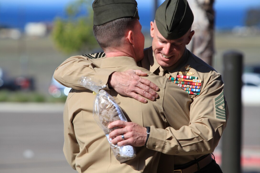 Lt. Col. Michael A. Brooks, the commanding officer of 1st Marine Special Operations Battalion, U.S. Marine Corps Forces, Special Operations Command, embraces Sgt. Maj. Garritt E. Duncan, during a change of command ceremony at Camp Pendleton, Calif., March 1. Brooks relinquished his command to Lt. Col. John J. Lynch during the ceremony.