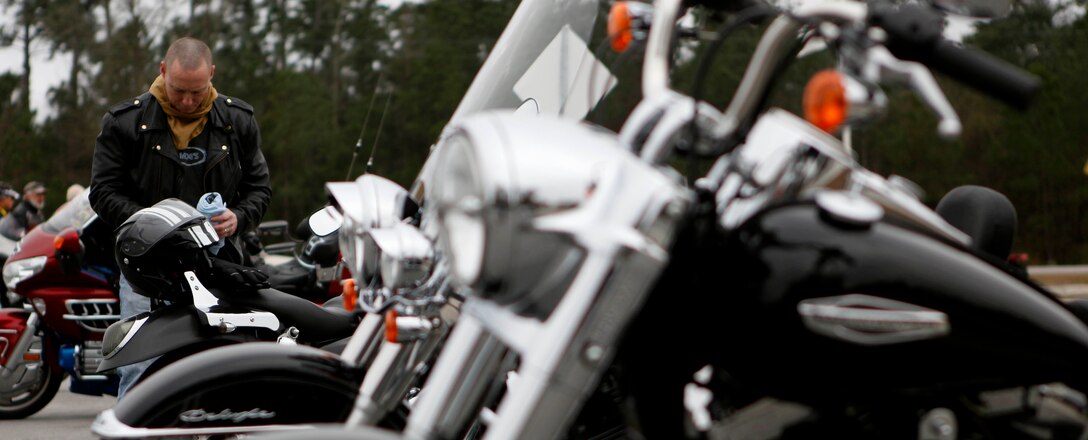 A rider prepares to get on his motorcycle and ride to the second location for the 11th Annual Chilly Chili Poker Run starting in Jacksonville Feb. 16. Rolling Thunder Chapter N.C.-5 hosted the poker run as a fundraiser for the Staff Sgt. Anthony L. Goodwin Memorial Scholarship fund for children of veterans.