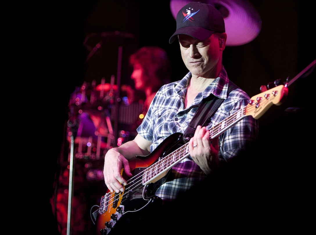MARINE CORPS BASE HAWAII - Gary Sinise, an actor, Academy Award nominee and bass guitarist for the Lt. Dan Band, plays his guitar during a concert on Marine Corps Base Hawaii, Feb. 22. Sinise, an avid supporter of service members, has toured military installations and performed concerts for troops and their families with the United Service Organizations since 2004. (U.S. Marine Corps photo by Lance Cpl. Suzanna Lapi) 