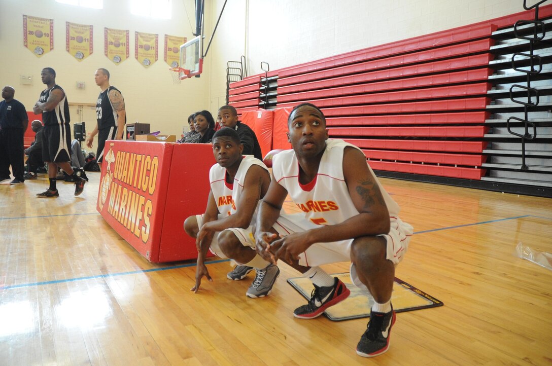 Anthony Johnson and Loren Thomas, players for the Quantico men’s varsity basketball team, prepare to check in during a varsity basketball game at Barber Physical Activity Center on March 3. Quantico lost to the Fort Meade Patriots 87-79.