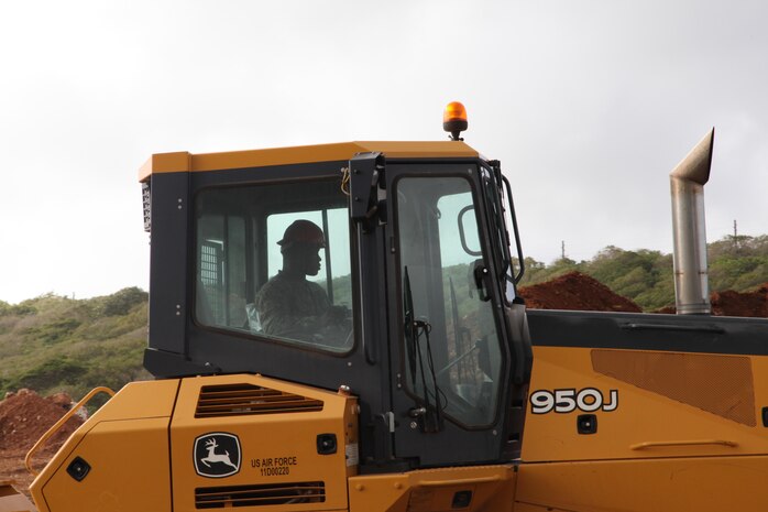 Lance Cpl. Kamara Alimamy, a heavy equipment operator with Combat Logistics Detachment 39, helps build a landfill area Feb. 26 on Andersen Air Base. Alimamy is part of Exercise Guahan Shield, an exercise that will facilitate multiservice engagement, set conditions for bilateral and multilateral training opportunities, and support rapid response to potential theater crises and contingency operations in the Asia-Pacific region. CLD-39 is part of Engineer Support Battalion, 3rd Marine Logistics Group, III Marine Expeditionary Force. 