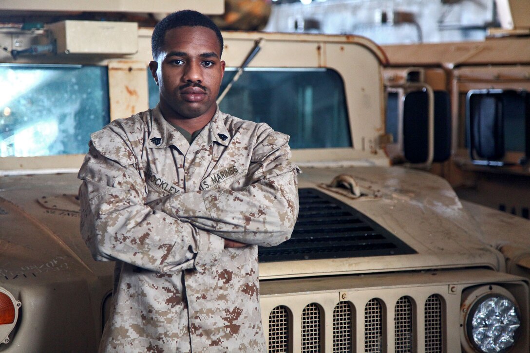 Sergeant Dereck Shockley, anti-tank guided missleman, Combined Anti-Armor Team 1, Weapons Company, Battalion Landing Team 3/5, 15th Marine Expeditionary Unit, poses for a photo in front of his vehicle aboard the USS Rushmore, Feb. 22. The 15th MEU is deployed as part of the Peleliu Amphibious Ready Group as a U.S. Central Command theater reserve force, providing support for maritime security operations and theater security cooperation efforts in the U.S. 5th Fleet area of responsibility. (U.S. Marine Corps photo by Cpl. Timothy R. Childers/ Released)
