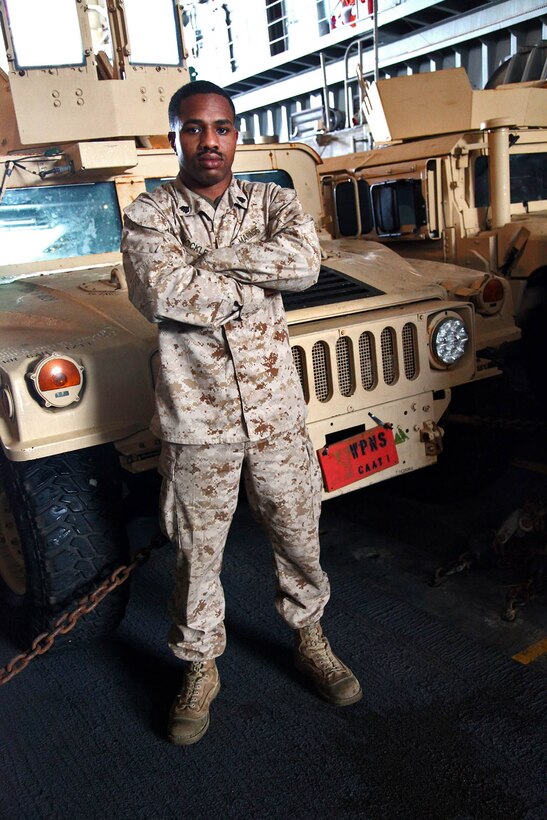 Sergeant Dereck Shockley, anti-tank guided missleman, Combined Anti-Armor Team 1, Weapons Company, Battalion Landing Team 3/5, 15th Marine Expeditionary Unit, poses for a photo in front of his vehicle aboard the USS Rushmore, Feb. 22. The 15th MEU is deployed as part of the Peleliu Amphibious Ready Group as a U.S. Central Command theater reserve force, providing support for maritime security operations and theater security cooperation efforts in the U.S. 5th Fleet area of responsibility. (U.S. Marine Corps photo by Cpl. Timothy R. Childers/ Released)