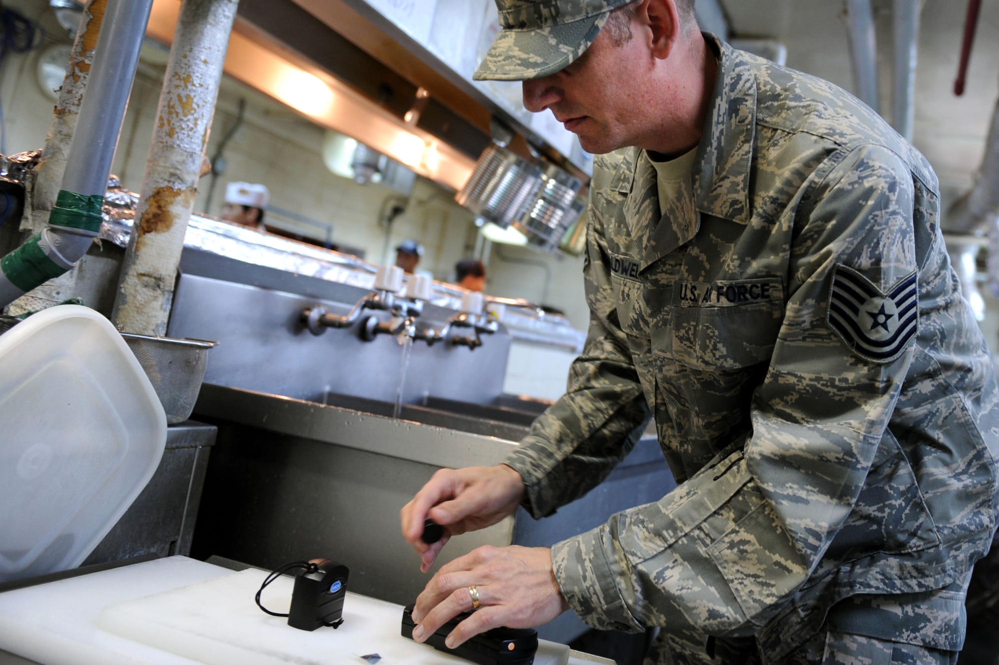 U.S. Air Force Tech. Sgt. Douglas Caldwell, Okuma independent medical technician, prepares a water sample at Okuma's Surfside Restaurant on Okuma, Japan, Feb. 2, 2013. As one of his extra duties, Caldwell helps with all the bio-environmental work such as water sampling and checking for cleanliness at the local restaurants. (U.S. Air Force photo/Airman 1st Class Brooke P. Doyle)
