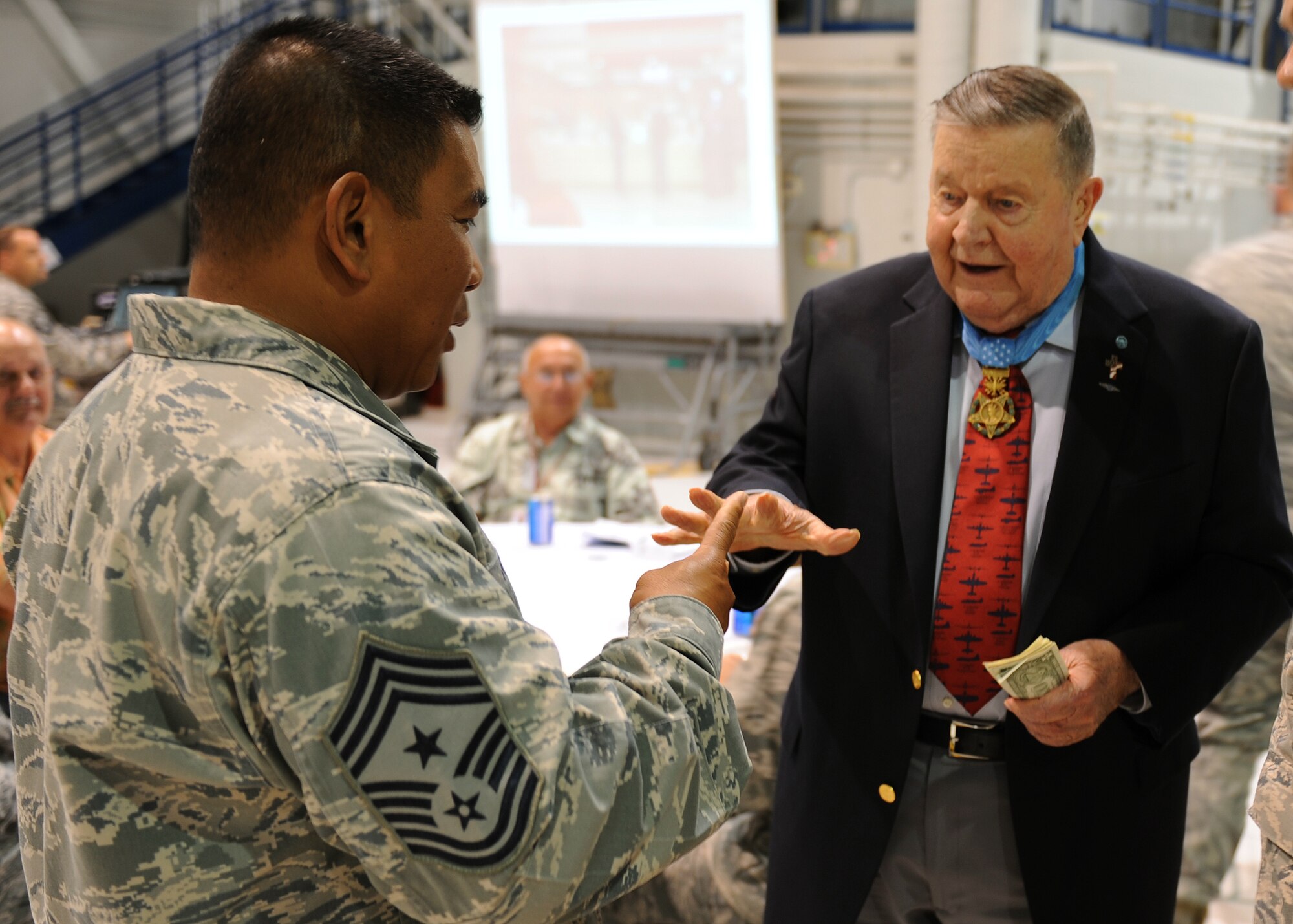 U.S. Air Force Medal of Honor recipient Col. (retired) Joe Jackson plays rock, paper, scissors as part of the night’s festivities with Chief Master Sgt. Willie P. Rafael, 154th Hawaii Air National Guard Wing command chief, during the 15th Maintenance Group’s Knucklebuster Banquet at Hangar 19, Joint Base Pearl Harbor-Hickam, Hawaii, March 1, 2013. Jackson was the guest speaker of the event. (U.S. Air Force photo/Staff Sgt. Terri Barriere)