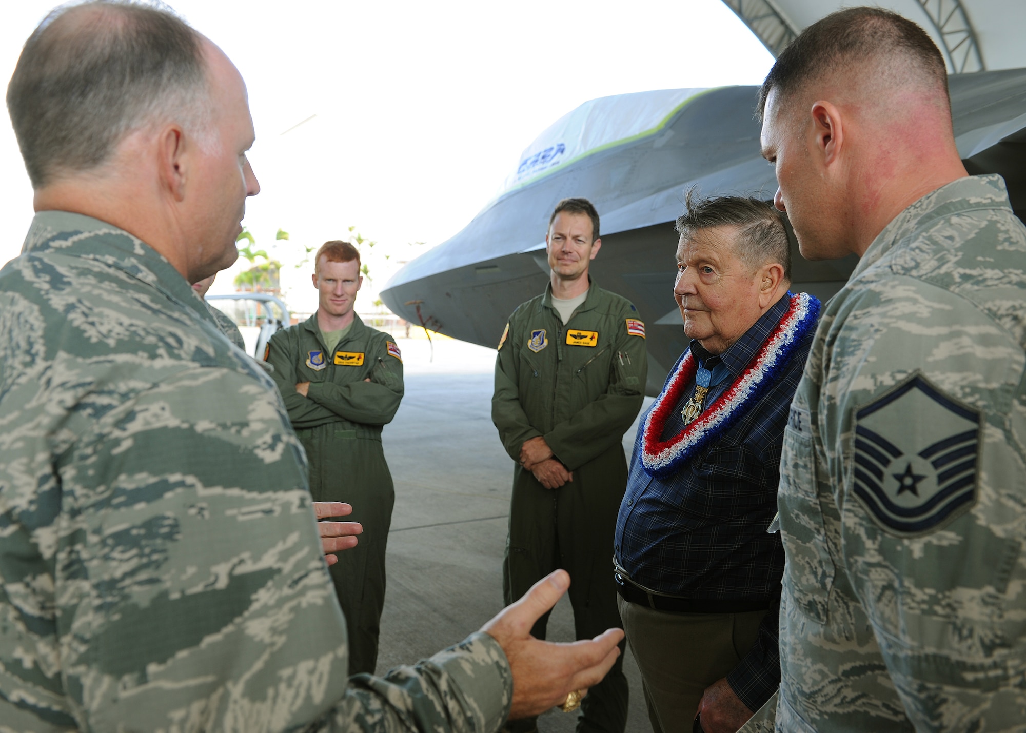 Senior leaders representing the 154th Hawaii Air National Guard and the 199th Fighter Squadron ask U.S. Air Force Medal of Honor recipient Col. (retired) Joe Jackson about his experiences as a life-long patriot, next to an F-22 Raptor near the flightline at Joint Base Pearl Harbor-Hickam, Hawaii, Mar. 1, 2013. Col. Jackson began his career as a crew chief on a B-25 Mitchell, and after an in-flight engine fire during an antisubmarine patrol over the North Atlantic, he decided he wanted pilot wings. At his time of retirement he piloted 32 different airframes. (U.S. Air Force photo/Tech. Sgt. Jerome S. Tayborn) 