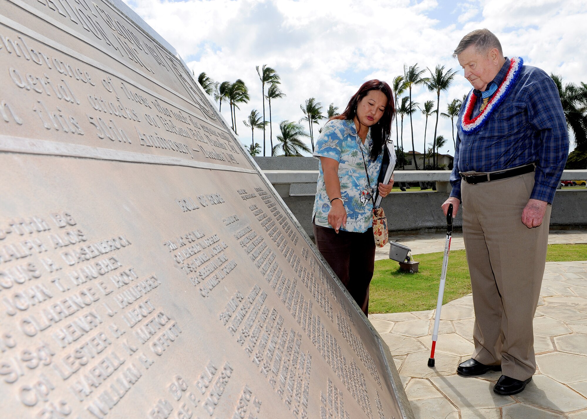 Jessie Higa, historian (left), shows U.S. Air Force Medal of Honor recipient Col. (retired) Joe Jackson an 11th Bombardment Group plaque, in remembrance  of those who made the supreme sacrifice as a result of enemy aerial attacks on Hickam Field, Dec. 7, 1941, at Atterbury Circle, Joint Base Pearl Harbor-Hickam, Hawaii, Mar. 1, 2013. Col. Jackson served 33 years of distinguished service and fought in World War II, Korea and Vietnam. (U.S. Air Force photo/Tech. Sgt. Jerome S. Tayborn)