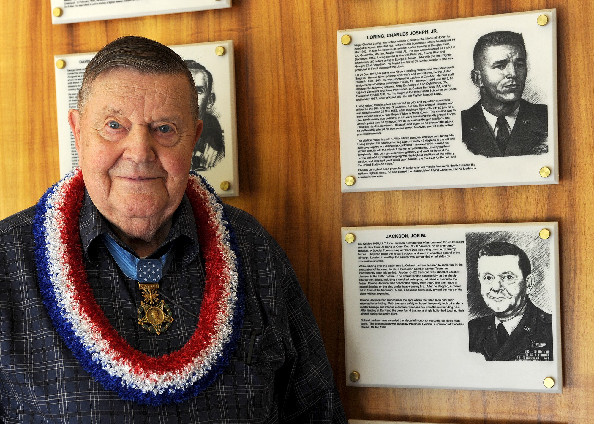 U.S. Air Force Medal of Honor recipient Col. (retired) Joe Jackson stands next to the plaque dedicated to him on the Wall of Valor at the Courtyard of Heroes, Joint Base Pearl Harbor-Hickam, Hawaii, Mar. 1, 2013. Col. Jackson earned the Medal of Honor in 1968 for the heroic rescue of a combat control team pinned to an exploding special forces camp called Kham Duc, South Vietnam. (U.S. Air Force photo/Tech. Sgt. Jerome S. Tayborn)