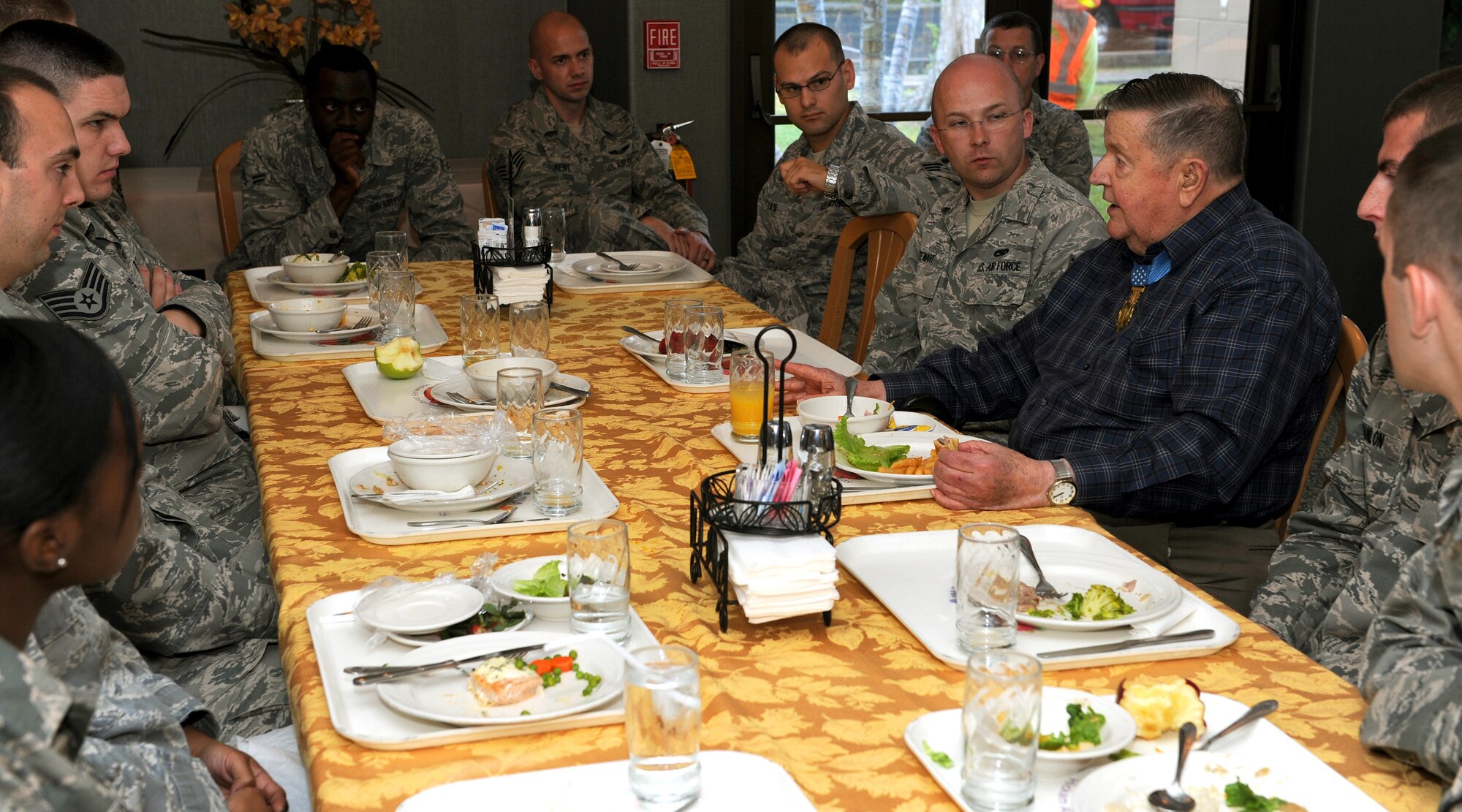U.S. Air Force Medal of Honor recipient Col. (retired) Joe Jackson (blue shirt) has lunch with Hickam Airmen and provides a first-hand account of how he earned the Medal of Honor, at the Hale Aina Dining Facility, Joint Base Pearl Harbor-Hickam, Hawaii, Mar. 1, 2013. Col. Jackson received the Medal of Honor in 1968 for a heroic rescue of a combat control team pinned to an exploding special forces camp called Kham Duc, South Vietnam. (U.S. Air Force photo/Tech. Sgt. Jerome S. Tayborn)