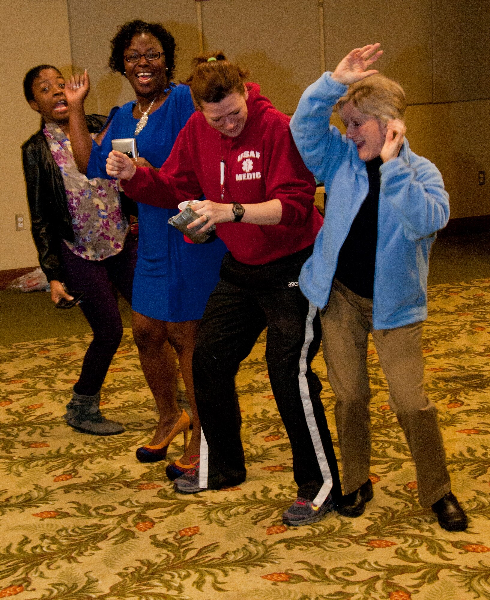 3/2/2013 – KEESLER AIR FORCE BASE, Miss. – Members of the 403rd Aeromedical Staging Squadron dance to tunes from the 1970s. "That 70's Party" was hosted by the 403rd ASTS Rising 6 as a social gathering. Pictured from left to right are Airman 1st Class Aquila Williams, Tech. Sgt. Tylar Ainsworth, Tech. Sgt. Mindy Bardell and Col. Barb Persons. (U.S. Air Force photo/Senior Airman L. Chris DeBlanc)