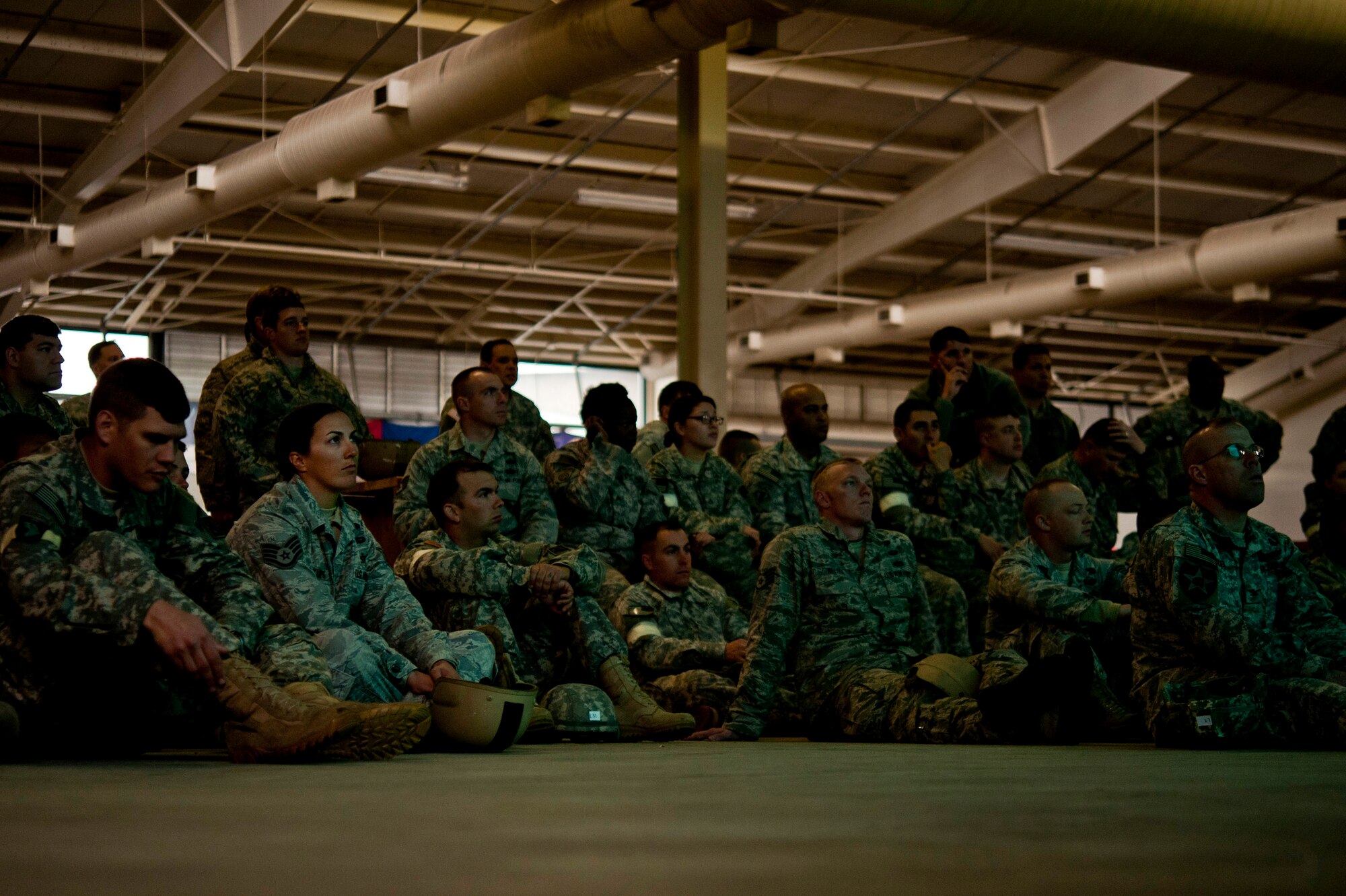 U.S. Air Force Airmen and Army Soldiers pay attention during a pre-jump mission briefing during a Joint Access Operation Exercise Feb. 23, 2013, at Fort Bragg, N.C. Female airborne engineers are accountable for just as much equipment as any of their male counterparts. (U.S. Air Force photo by Senior Airman Daniel Hughes)