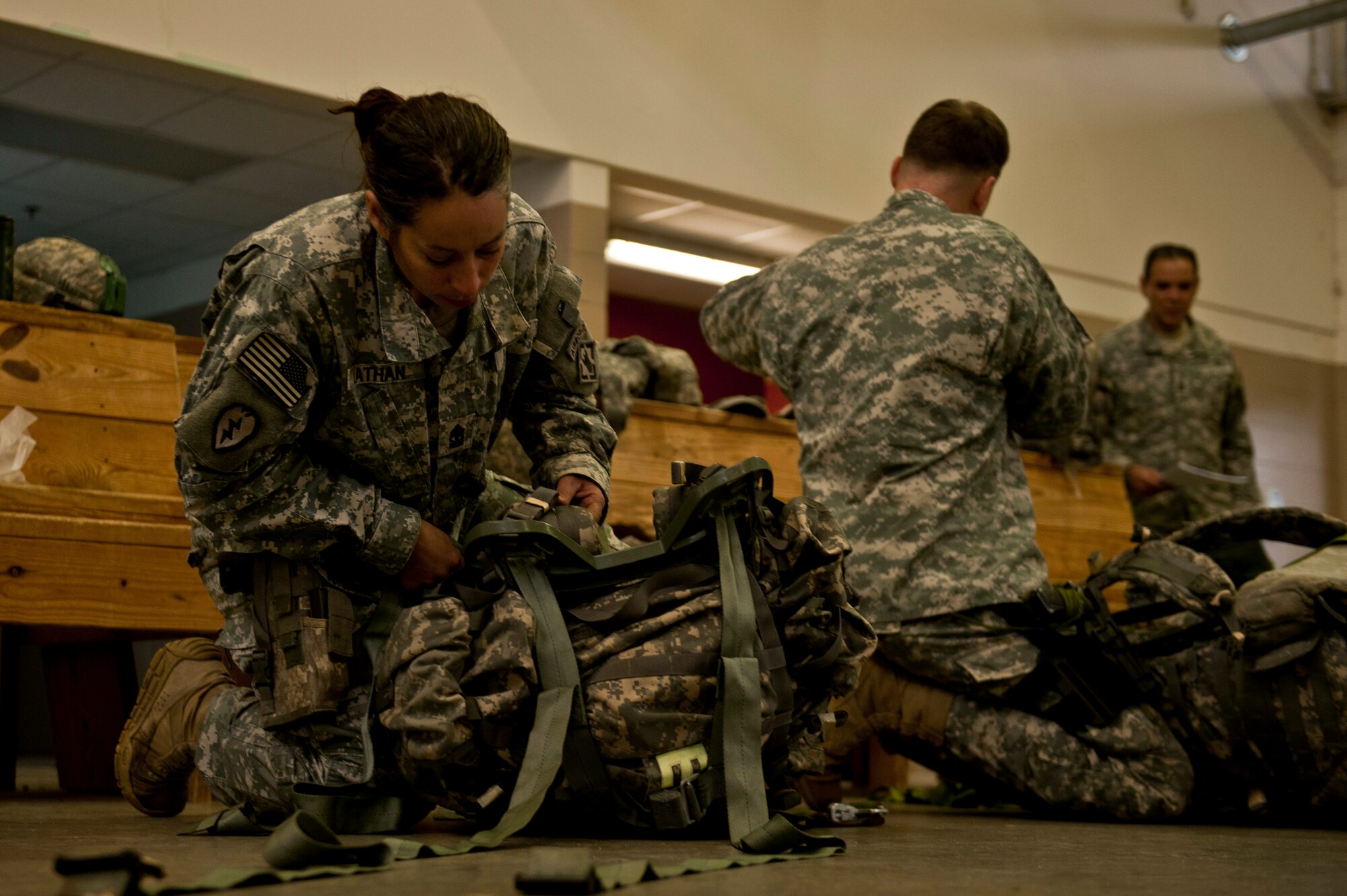 U.S. Army 1st Sgt. Bianka Lathan, 161st Engineer Support Company combat airborne, tightens down her rucksack before participating in a Joint Access Operation Exercise jump mission Feb. 23, 2013, at Fort Bragg, N.C. Lathan, the first female 1st Sgt. for the 161st , graduated jump master school last week. (U.S. Air Force photo by Senior Airman Daniel Hughes)