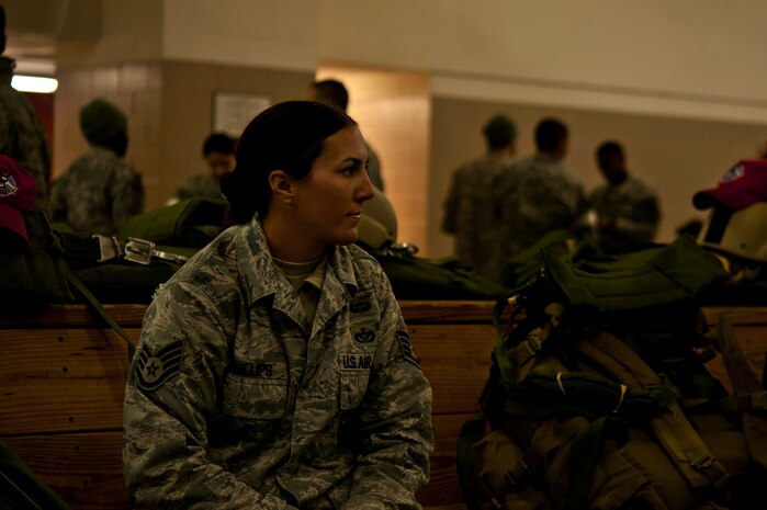 U.S. Air Force Staff Sgt. Christine Phillips, 820th Rapid Engineer Deployable Heavy Operational Repair Squadron Engineers Airborne from Nellis Air Force Base, Nev., waits as fellow Airborne jumpers get their gear ready to participate in a Joint Access Operation Exercise jump mission Feb. 23, 2013, at Fort Bragg, N.C. Phillips is the only female jump qualified Airman in the 820th RED HORSE Airborne squadron. (U.S. Air Force photo by Senior Airman Daniel Hughes)