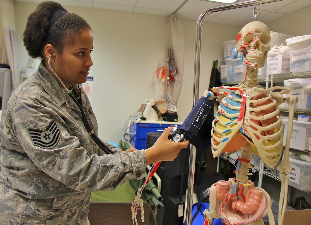 Tech. Sgt. Asia Bell takes blood pressure readings from an atypical patient in the 932nd Medical Group's skills lab.   Bell is a traditional reservist, who commutes from Arizona  each month to drill with the 932nd Medical Squadron.  Her skills as a medical technician in the Air Force Reserve is an ideal fit in Bell's civilian job, as a licensed practical nurse.  Bell said she loves both careers and is taking courses to become a registered nurse.  (U.S. Air Force photo/Tech. Sgt. Dan Oliver) 