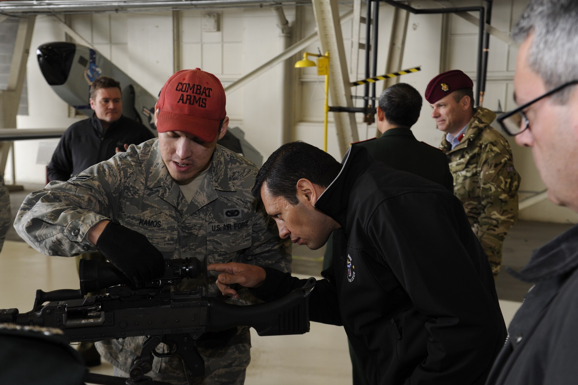 Senior Airman Herbert Ramos, 92nd Security Forces Squadron combat arms instructor, shows members from the Army War College and the International Fellows the scope on a rifle at Fairchild Air Force Base, Wash., Feb. 27, 2013. For the Army War College and International fellows, this was their first time visiting Fairchild Air Force Base and an awesome one according to the gentlemen. (U.S. Air Force photo by Airman 1st Class Ryan Zeski)
