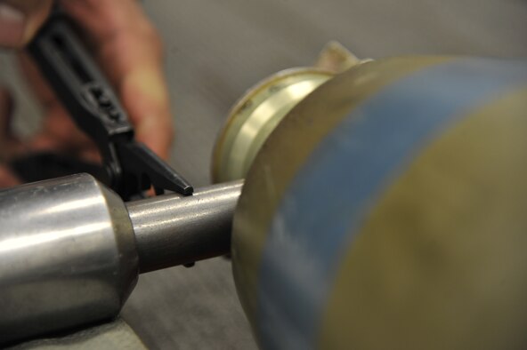 WHITEMAN AIR FORCE BASE, Mo. -- Airman 1st Class Fernando Aguilera, 509th Civil Engineer Squadron Explosive Ordnance Disposal team member, measures the point of impact of the standard slug, Feb. 27. The point of impact is where the slug is supposed to hit, and measurements have to be precise for the bomb to be safely defused. (U.S. Air Force photo/ Airman 1st Class Keenan Berry) (Released) 
