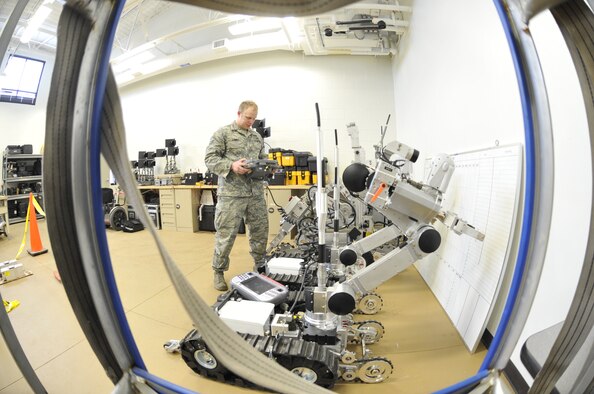 WHITEMAN AIR FORCE BASE, Mo. -- Airman 1st Class Jeff Kinney, 509th Civil Engineer Squadron Explosive Ordnance Disposal team member, performs a function check on the AFMSR and the F-6 robot, Feb. 27. These robots are both designed to destroy improvised explosive devices. (U.S. Air Force photo/Airman 1st Class Keenan Berry) (Released) 
