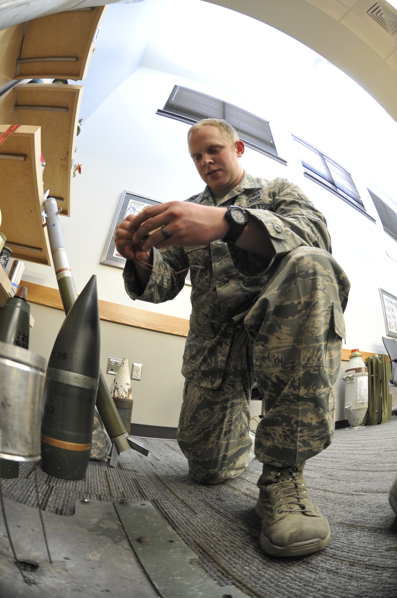 WHITEMAN AIR FORCE BASE, Mo. -- Airman 1st Class Jeff Kinney, 509th Civil Engineer Squadron Explosive Ordinance Disposal team member, studies the effects of an improvised breaking charge, Feb. 27. This device is used to open up packages, breach armor, and blow up targets. (U.S. Air Force photo/Airman 1st Class Keenan Berry) (Released)